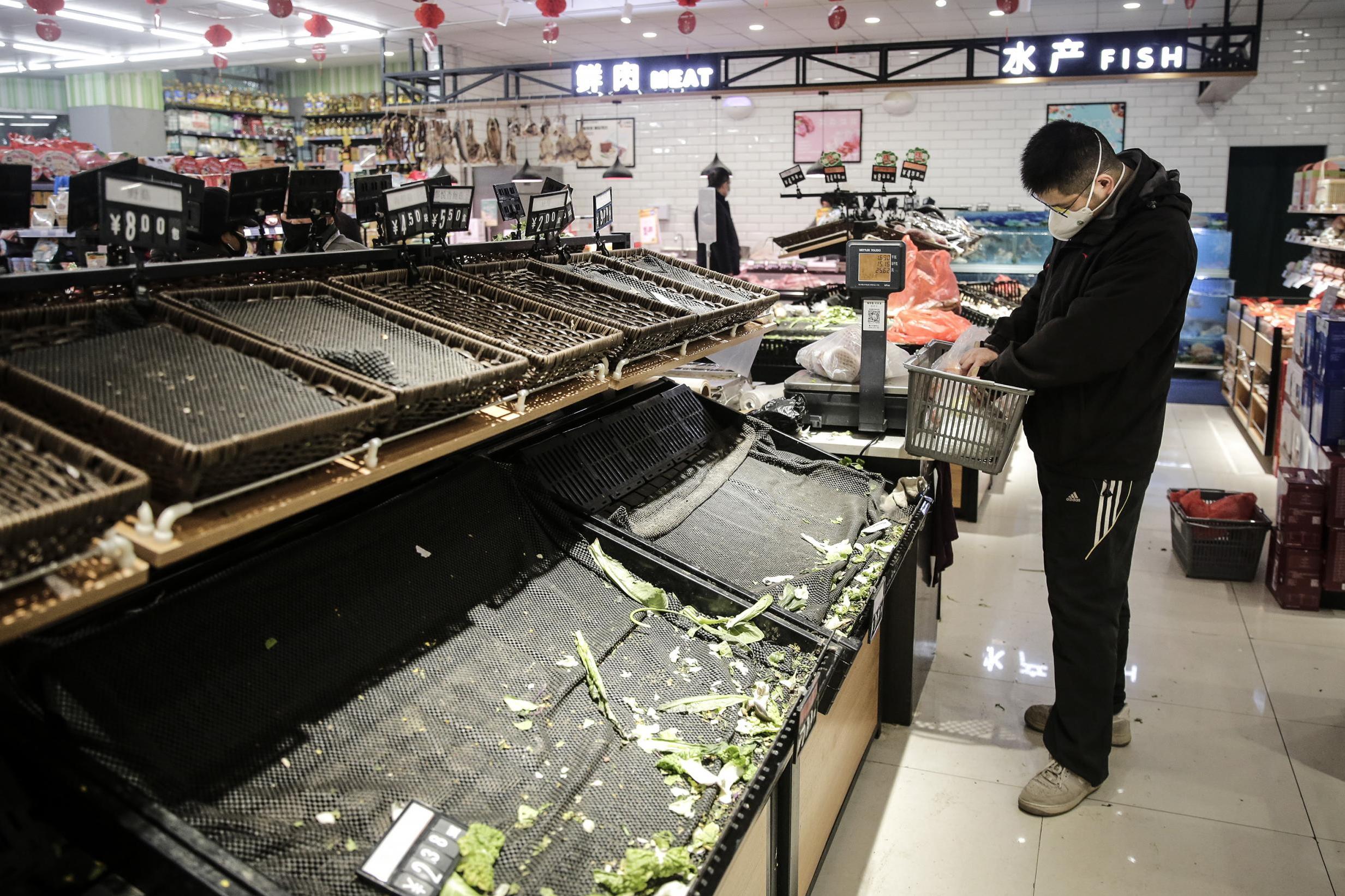 The rush to procure food, essentials and protective gear in the city has seen panic-stricken residents emptying shelves (Getty)