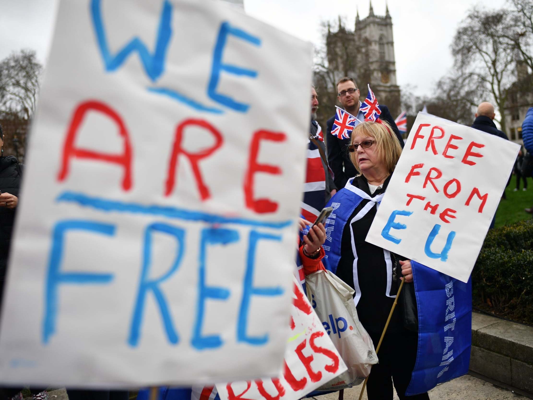 Brexit supporters hold placards at Parliament Square yesterday