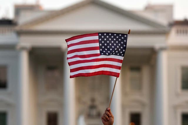 In this September 2017 file photo, a flag is waved outside the White House, in Washington