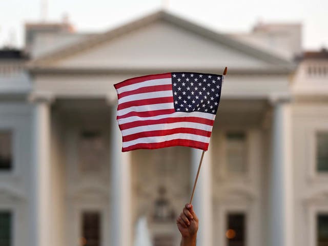 <p>In this September 2017 file photo, a flag is waved outside the White House, in Washington</p>