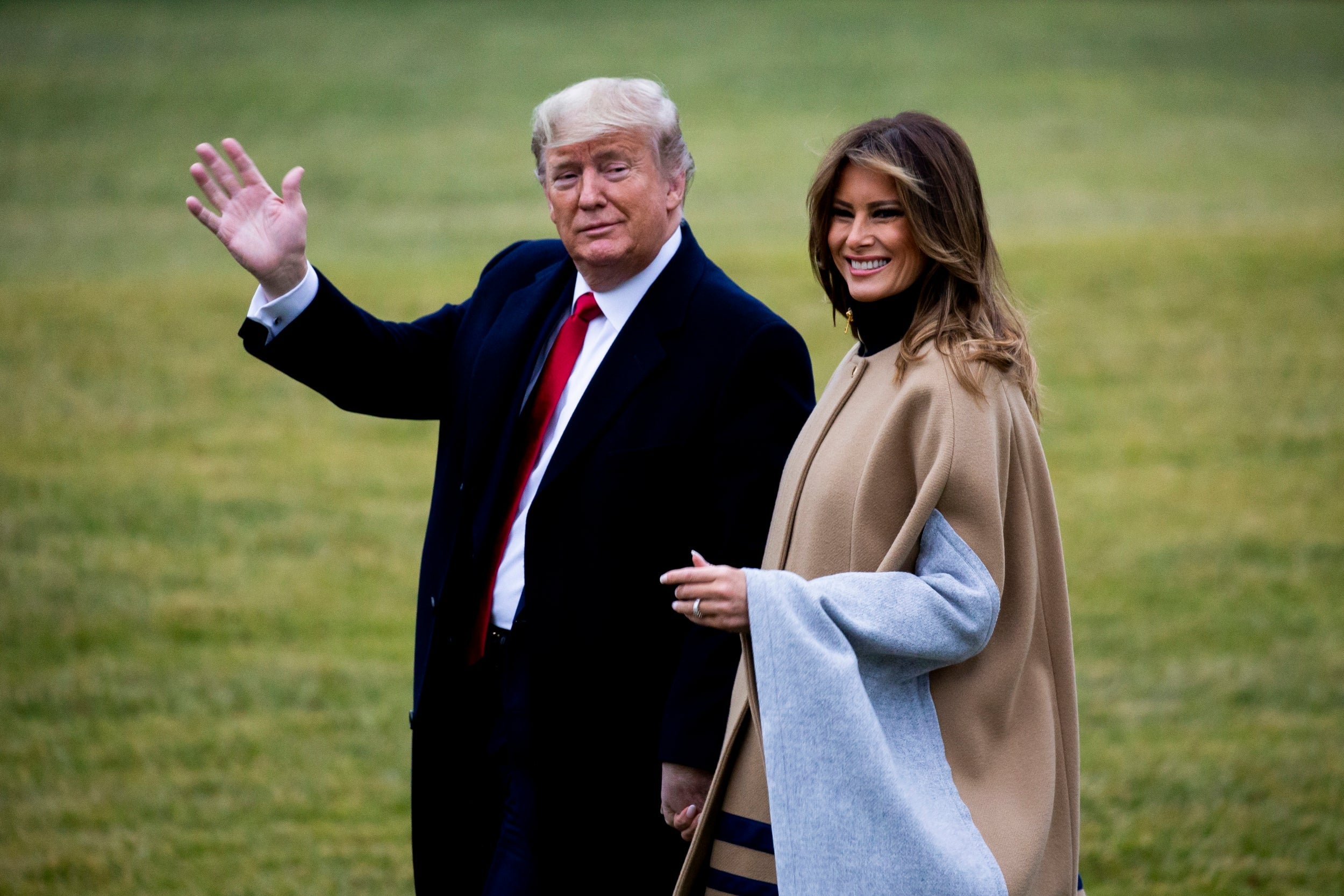 Donald Trump waves to reporters as he leaves the White House with the first lady shortly before the Senate vote (Michael Reynolds/EPA)