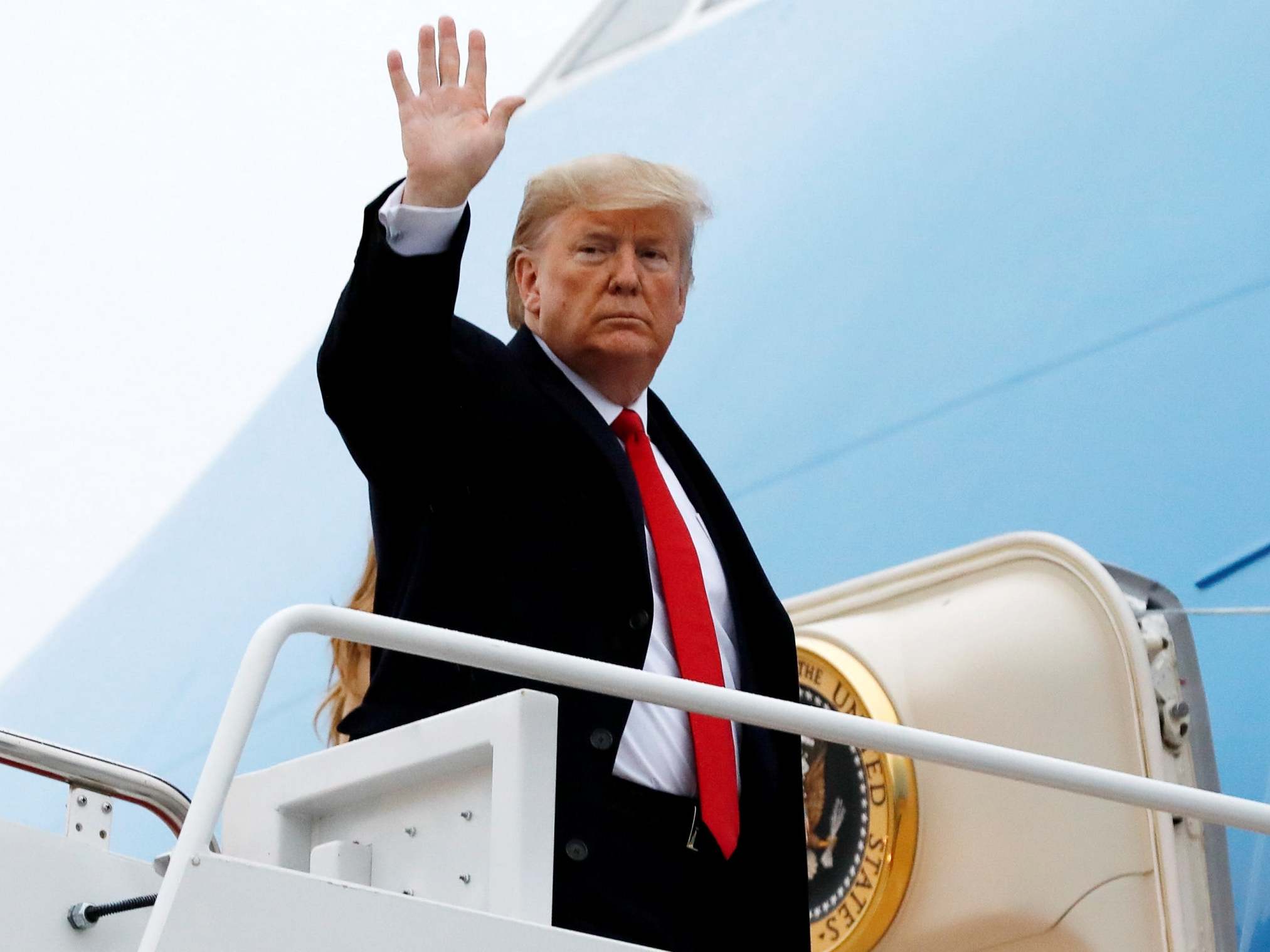 Donald Trump waves as he boards Air Force One on 31 January