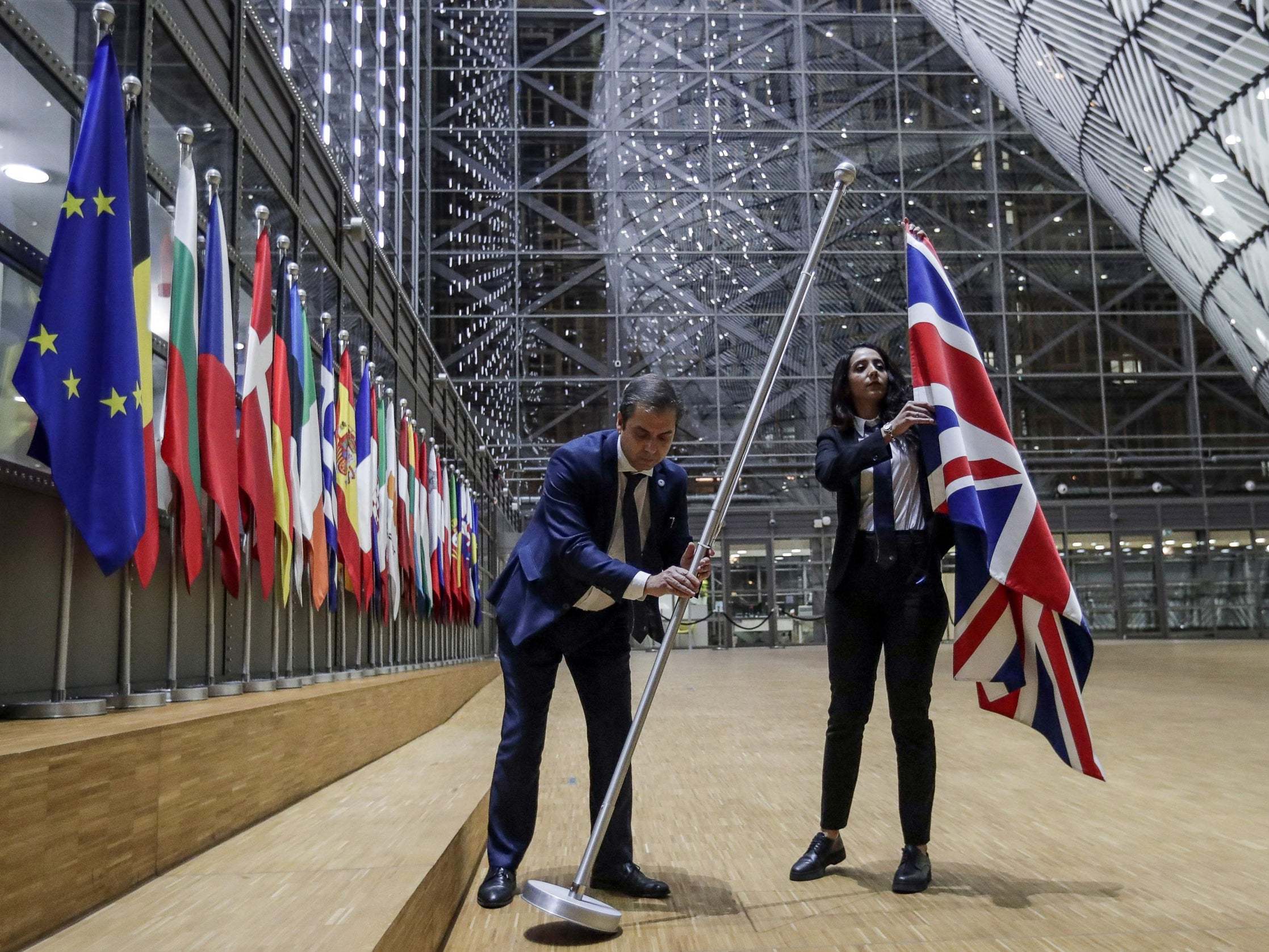EU Council staff remove the United Kingdom's flag from the European Council building in Brussels on Brexit Day, 31 January, 2020.