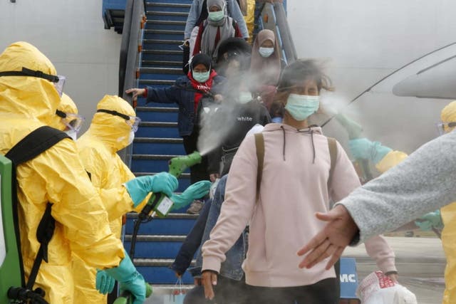 Medical officers spray Indonesian nationals with antiseptic after they arrived from Wuhan, China, at Hang Nadim Airport in Batam, Riau Islands, 2 February, 2020.