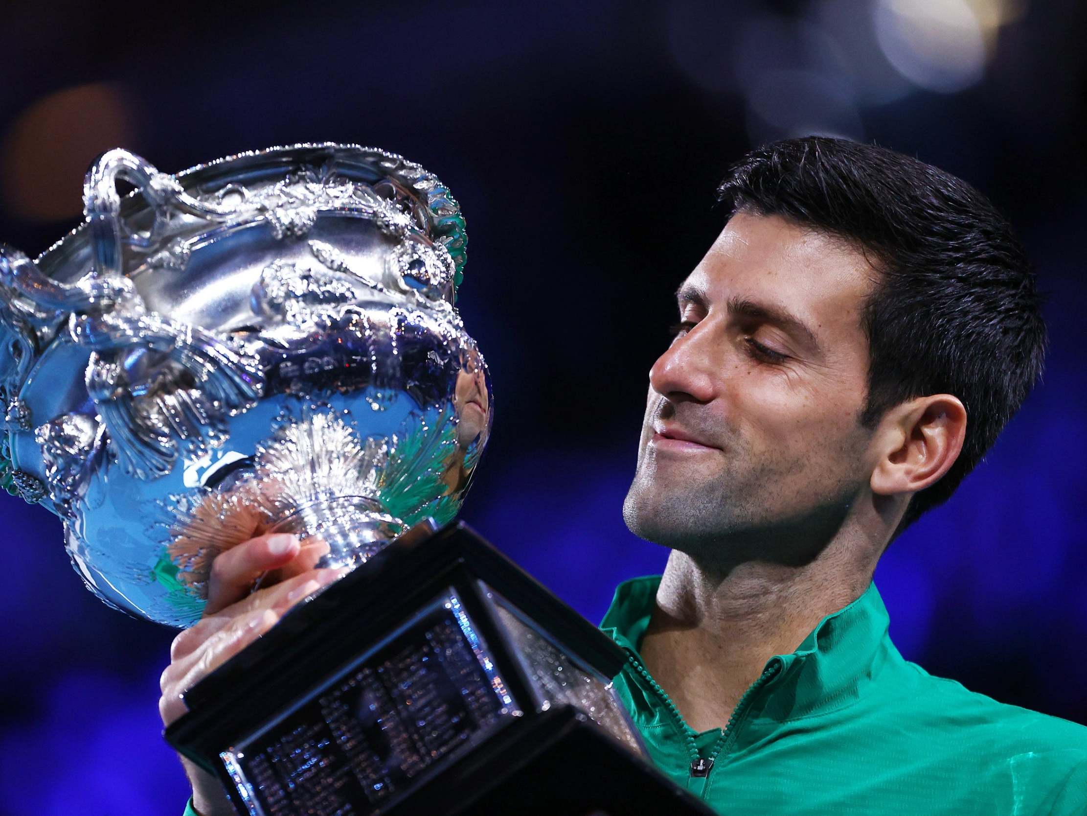 Novak Djokovic celebrates winning a record-extending eighth Australian Open