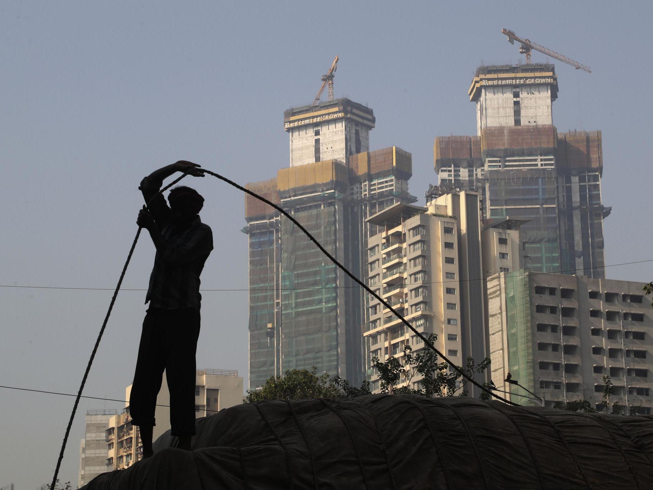 A man works near buildings under construction in Mumbai on 1 February