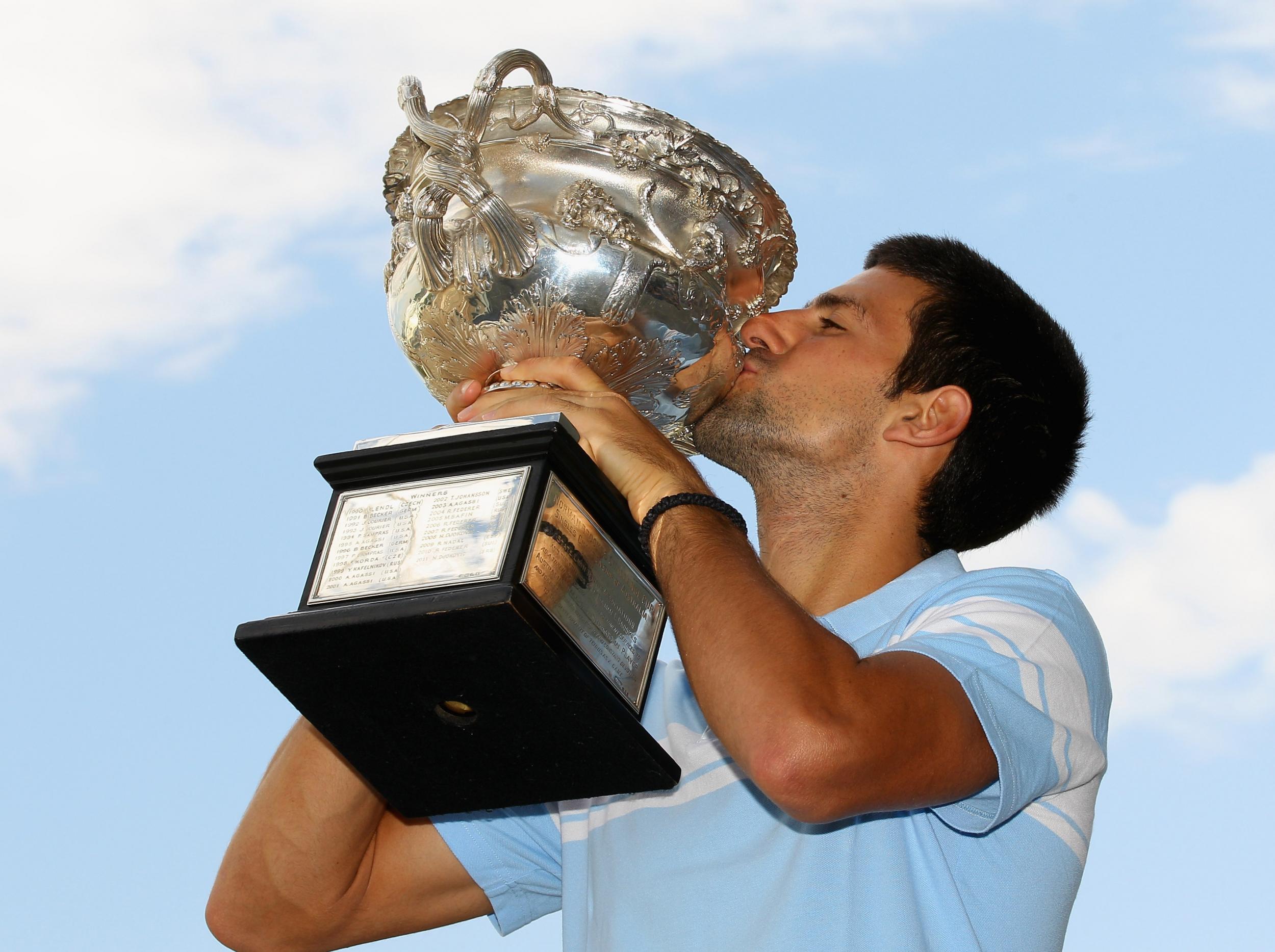 Djokovic poses with the Norman Brookes Challenge Cup, in 2011