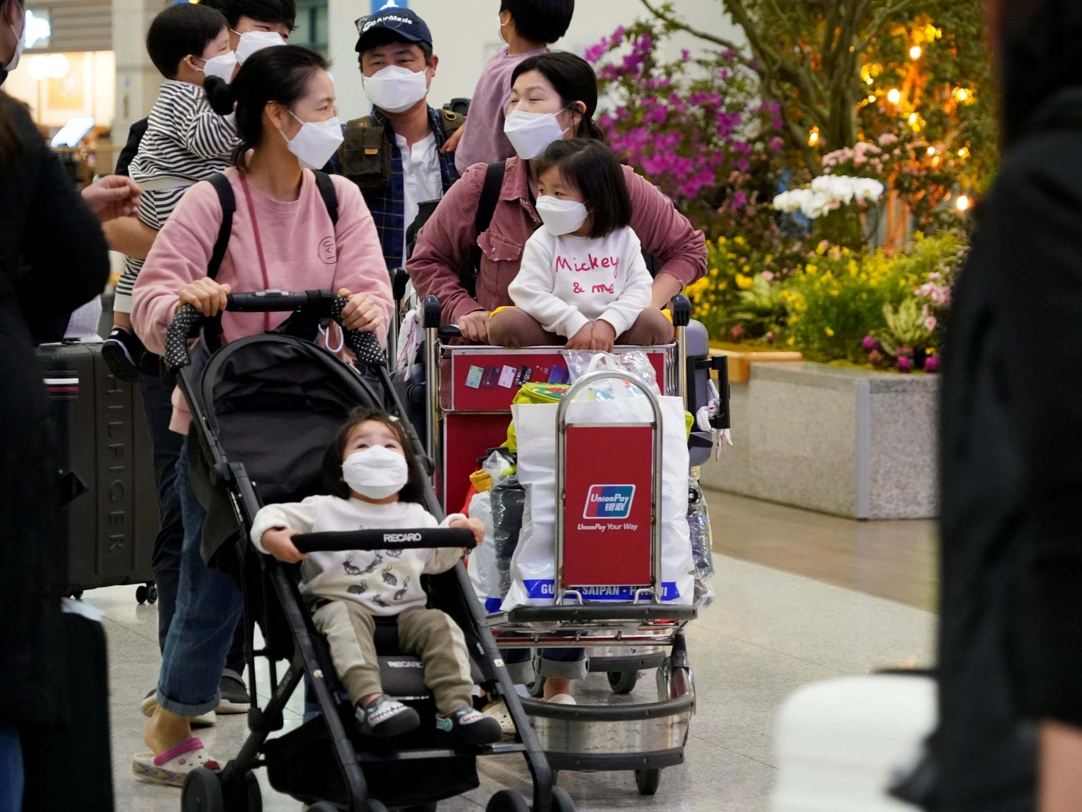 People wearing masks to prevent contracting coronavirus walk at Incheon International Airport in Incheon, South Korea