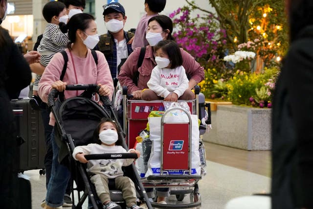 People wearing masks to prevent contracting coronavirus walk at Incheon International Airport in Incheon, South Korea
