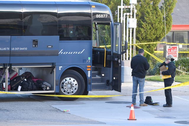 Investigators at the scene of a shooting on a Greyhoud bus near Bakersfield, California, in which one person was killed and five others injured
