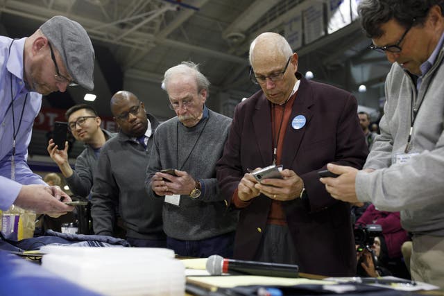 DES MOINES, IA - FEBRUARY 03: Officials from the 68th caucus precinct overlook the results of the first referendum count during a caucus event on February 3, 2020 at Drake University in Des Moines, Iowa, United States. Iowa is the first contest in the 2020 presidential nominating process with the candidates then moving on to New Hampshire.