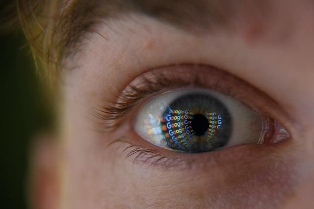 In this photo illustration, an image of the Google logo is reflected on the eye of a young man on August 09, 2017 in London, England