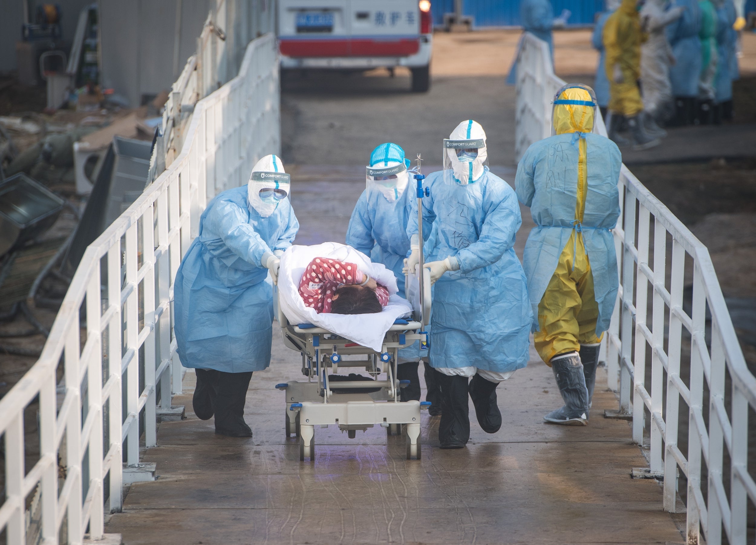 Medical workers help the first batch of patients infected with the novel coronavirus move into their isolation wards at the newly-built Huoshenshan Hospital in Wuhan