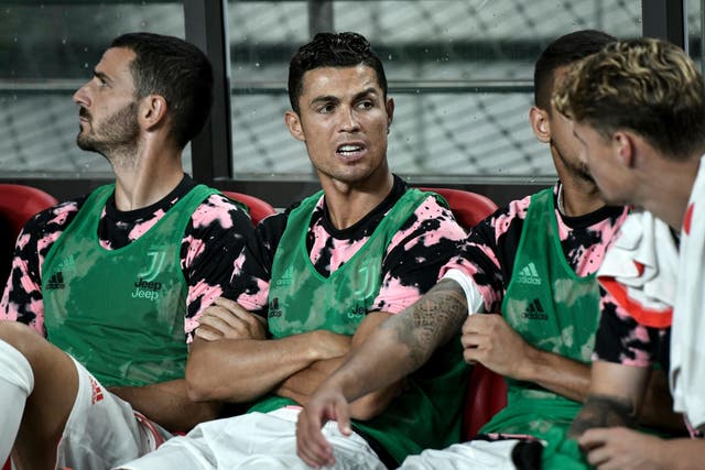 Cristiano Ronaldo sits on the team bench