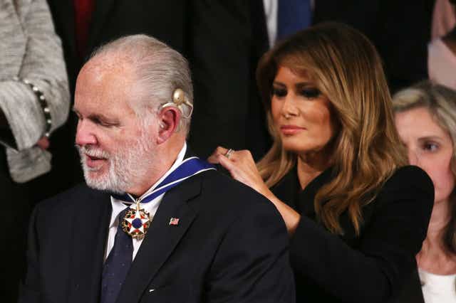 Melania Trump ties the Presidential Medal of Freedom round the neck of right-wing radio host Rush Limbaugh during the State of the Union address by her husband