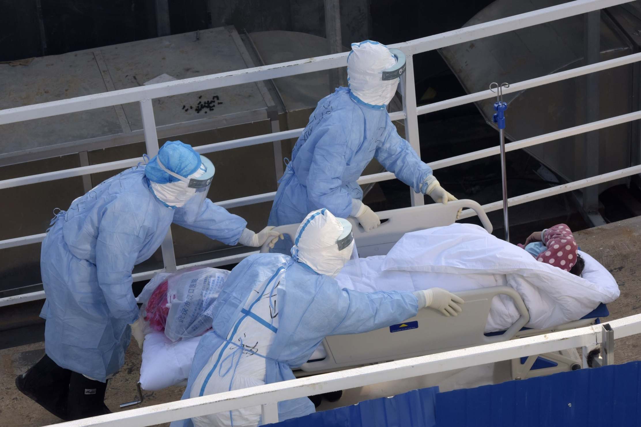 Medical workers help patients move into isolation wards in Wuhan