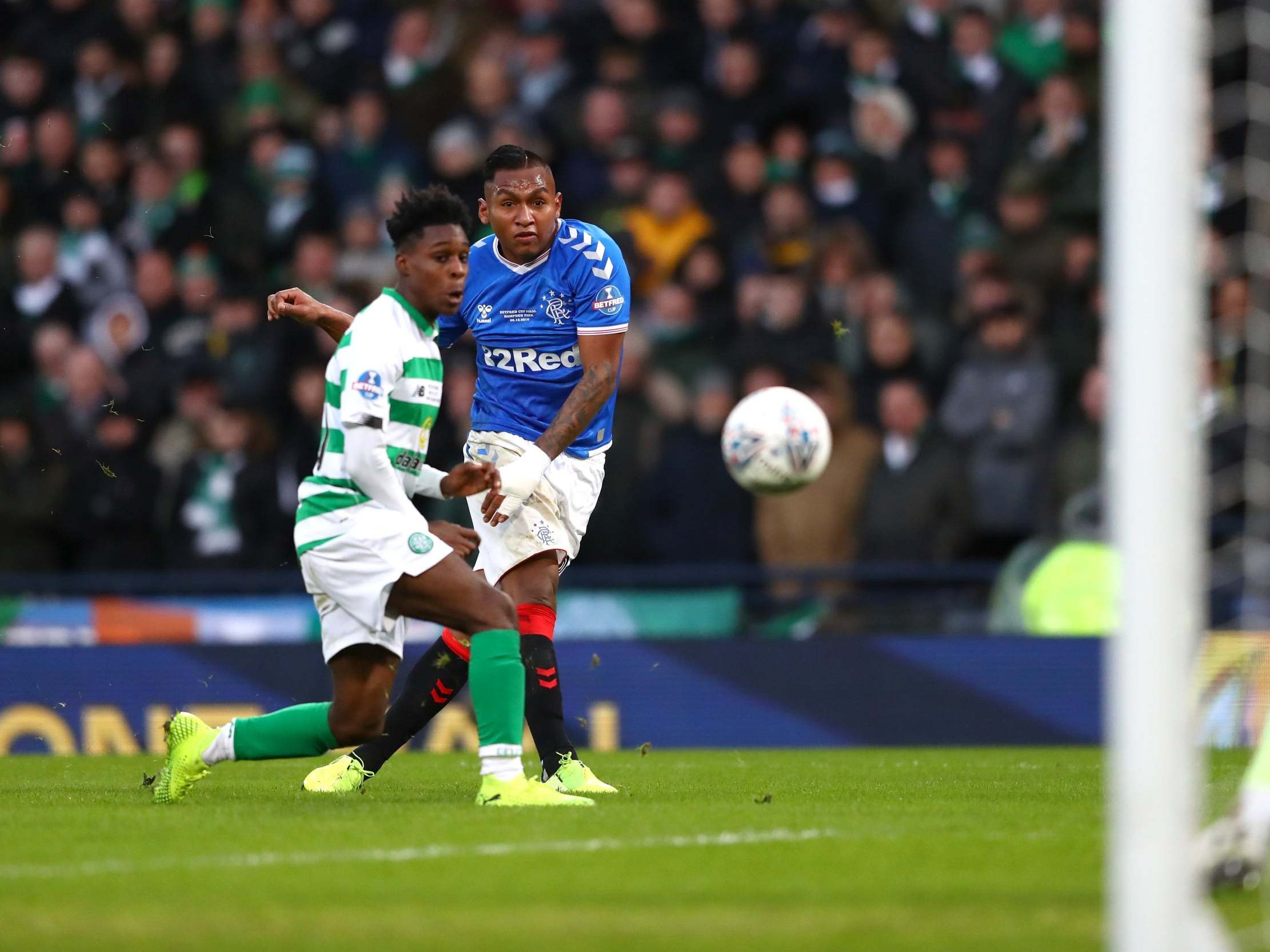 Alfredo Morelos shoots against Celtic under pressure from Jeremie Frimpong