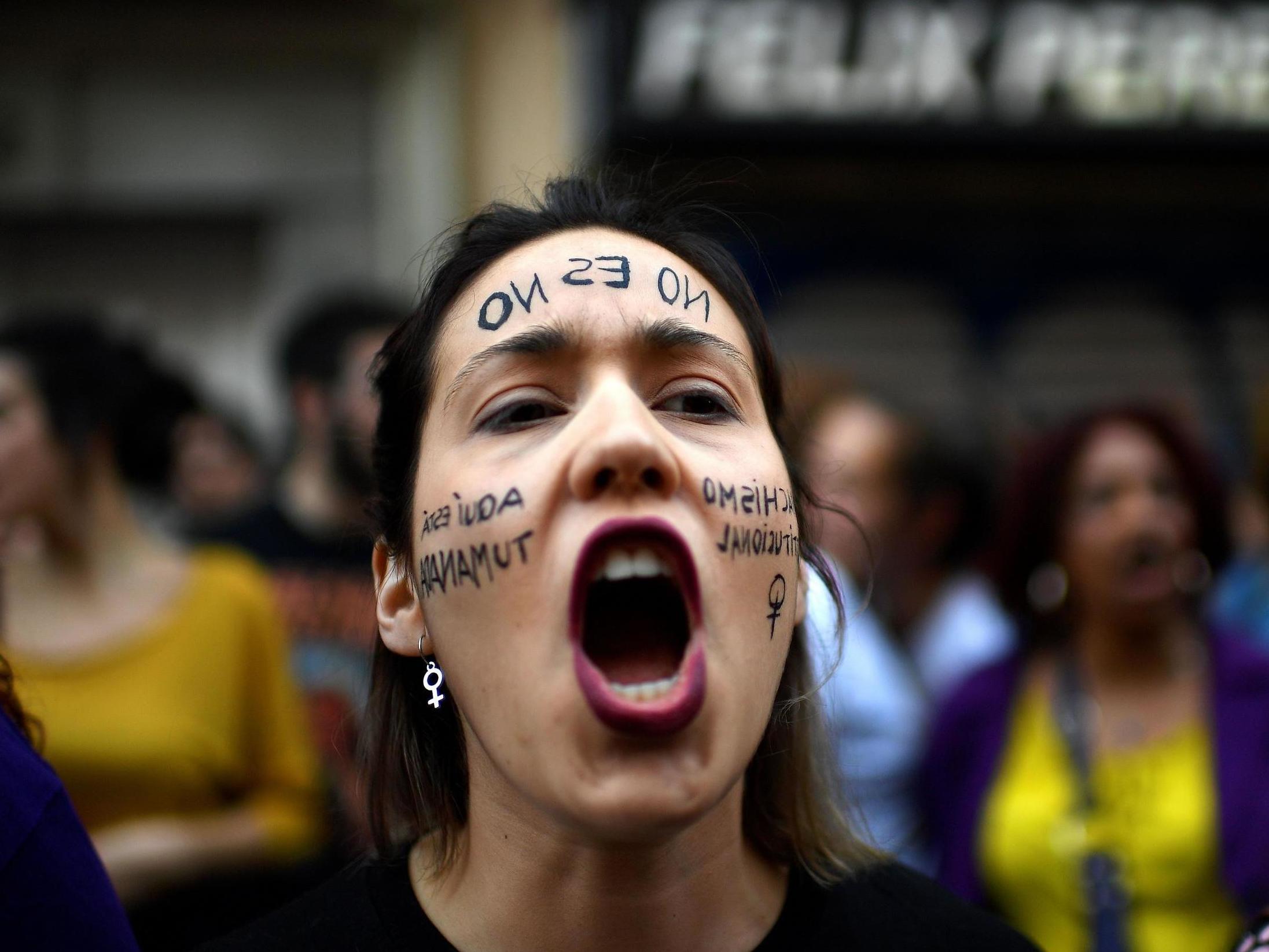 A woman shouts slogans during a demonstration in Madrid on April 26 2018, to protest after five men accused of gang raping a woman at Pamplona's bull-running festival were sentenced for "sexual abuse"