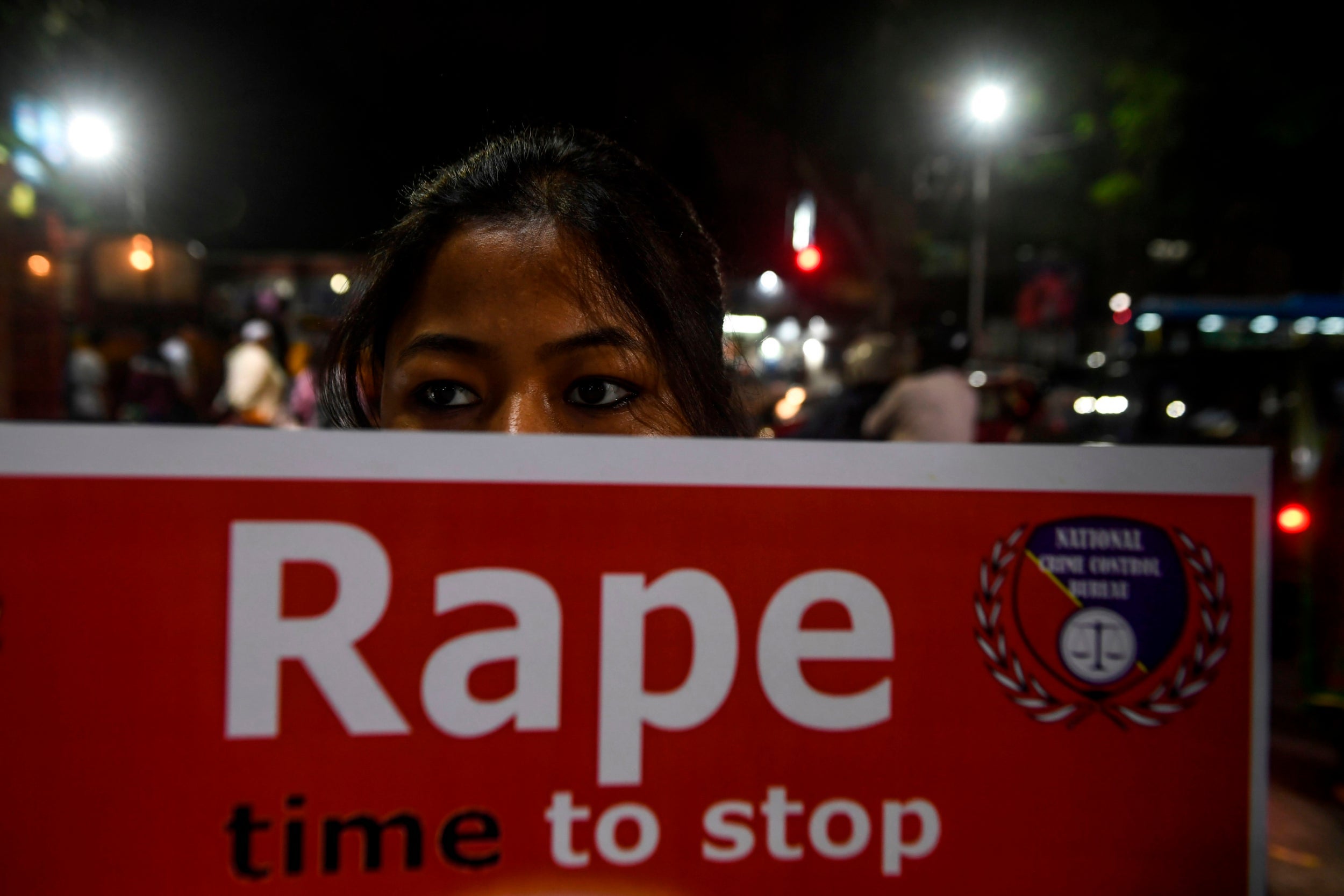 File: A demonstrator holds a placard to protest against sexual assaults on women in December, 2019