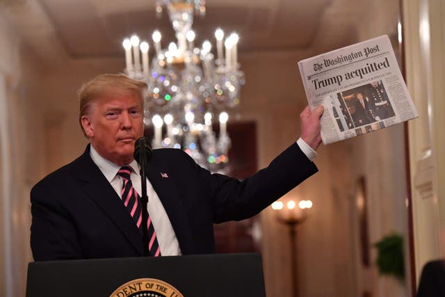 Donald Trump holds up ‘The Washington Post’ as he speaks to supporters at the White House, following his impeachment acquittal by allies in the Senate