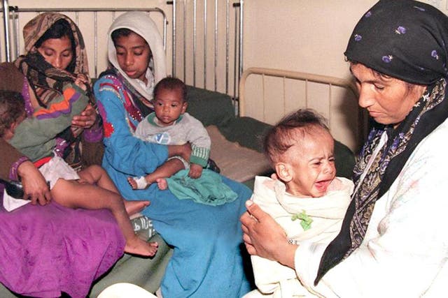 Iraqi women nurse their sick children in a Baghdad hospital in 1998 – these are the real victims of sanctions