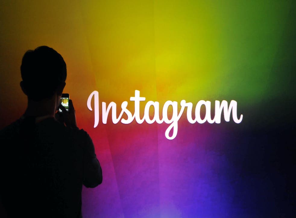 An Instagram employee takes a video using Instagram's new video function at Facebook's corporate headquarters during a media event in Menlo Park, California on June 20, 2013
