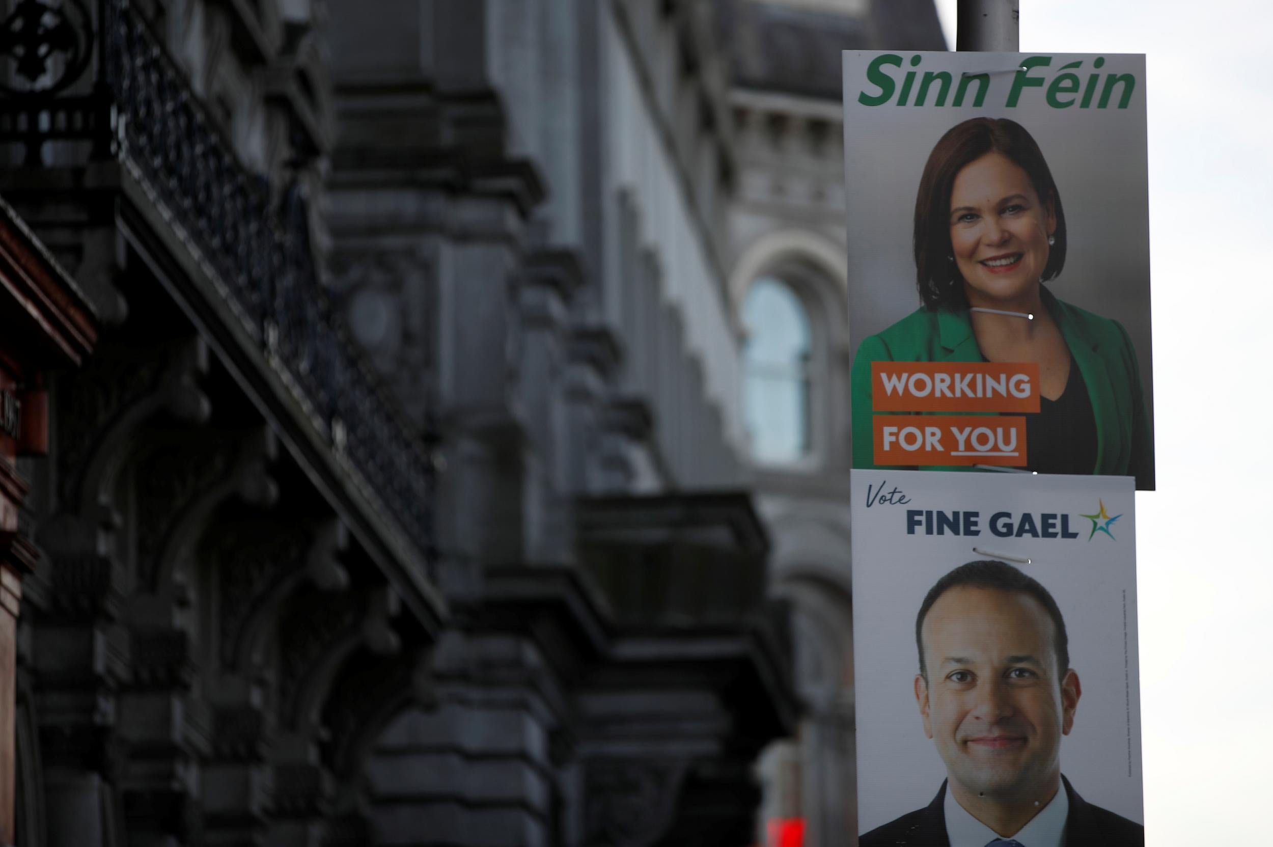 Sinn Fein leader Mary Lou McDonald’s election poster sits above that of Fine Gael leader Leo Varadkar in central Dublin (Reuters)