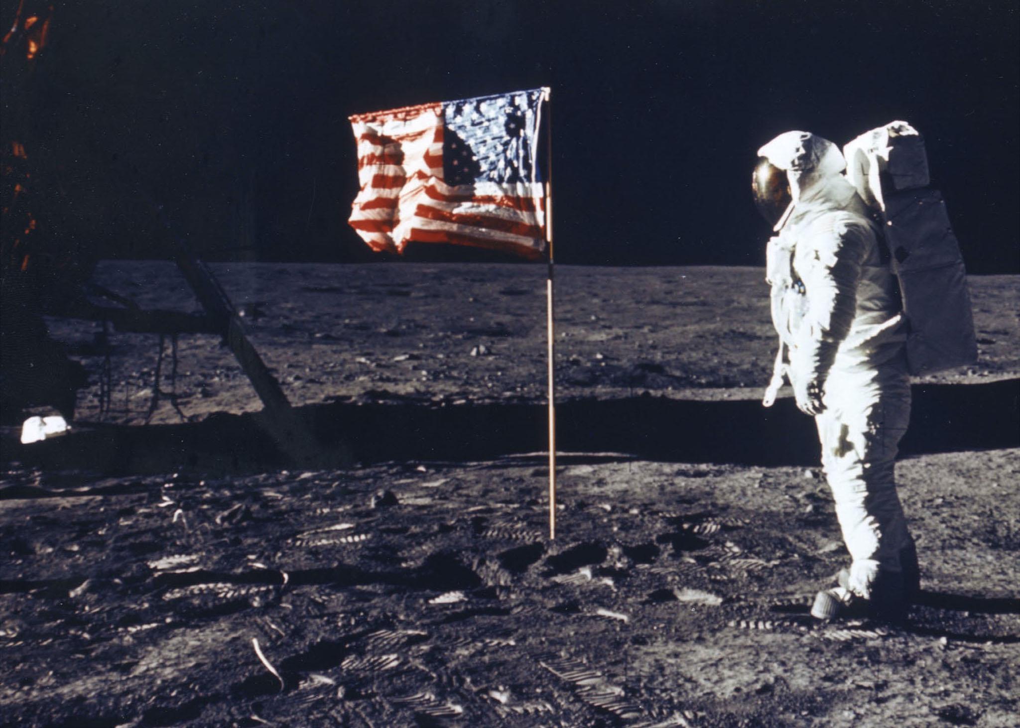 Astronaut Edwin E. Aldrin Jr. Poses For A Photograph Beside The Deployed Flag Of The United States