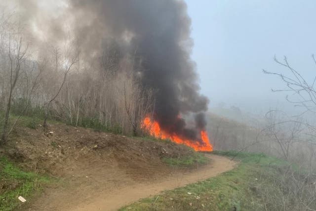 Smoke and flames rise up from the spot where Kobe Bryant's helicopter crashed.