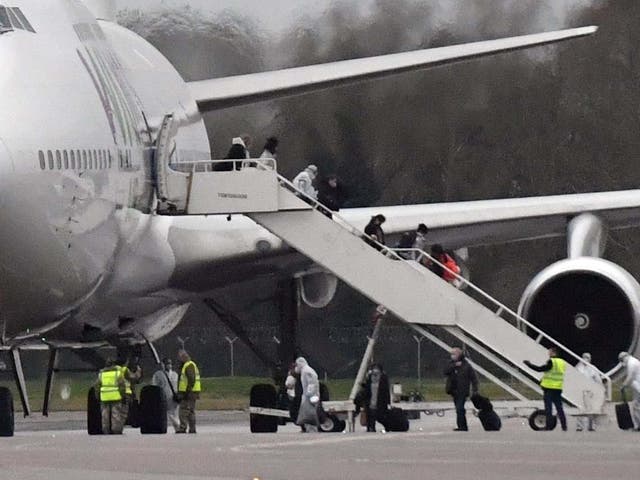 Passengers disembarking an aircraft repatriating British and other nationalities to the UK from Wuhan