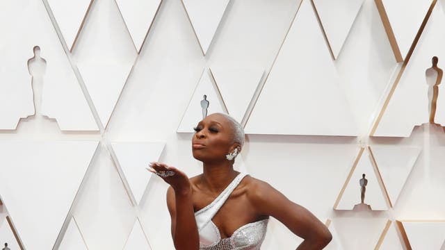 Cynthia Erivo blew a kiss as she posed in her futuristic white and silver Versace gown and Maria Tash jewellery.