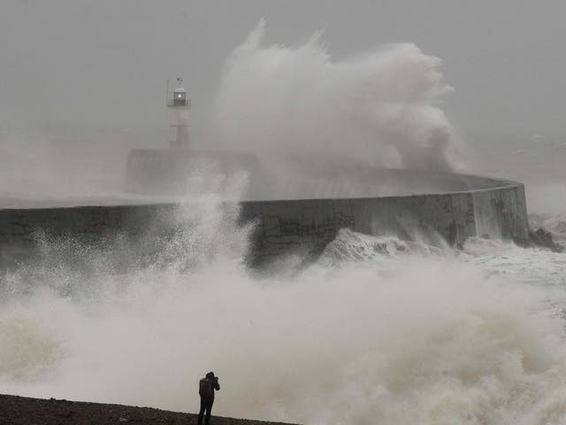 A man photographs large waves caused by Storm Ciara as they hit the the seafront and wall in Newhaven, East Sussex, 9 February, 2020.