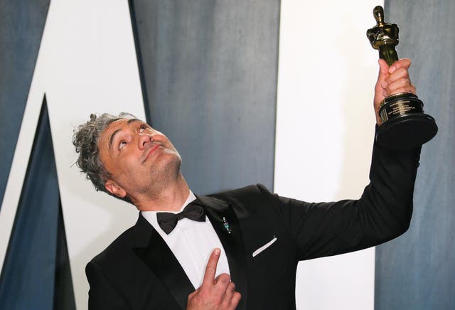 New Zealand director-actor Taika Waititi poses with his award for Best Adapted Screenplay for "Jojo Rabbit" as he attends the 2020 Vanity Fair Oscar Party