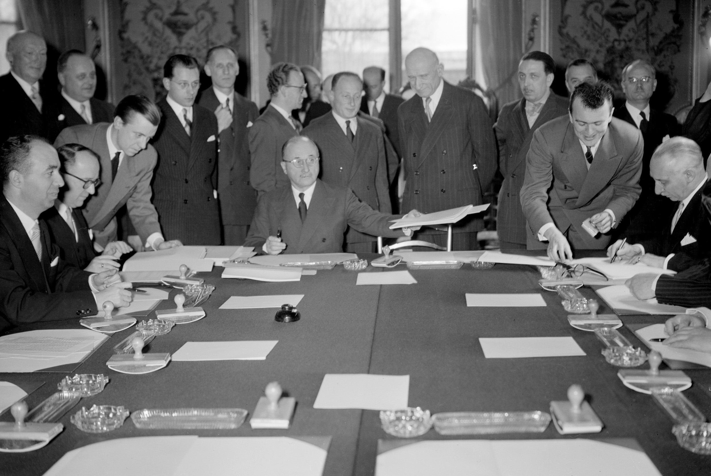 Jean Monnet signs a treaty in 1951 to create the European Coal and Steel Community, which enabled the sharing of mining resources among several European countries (AFP/Getty)