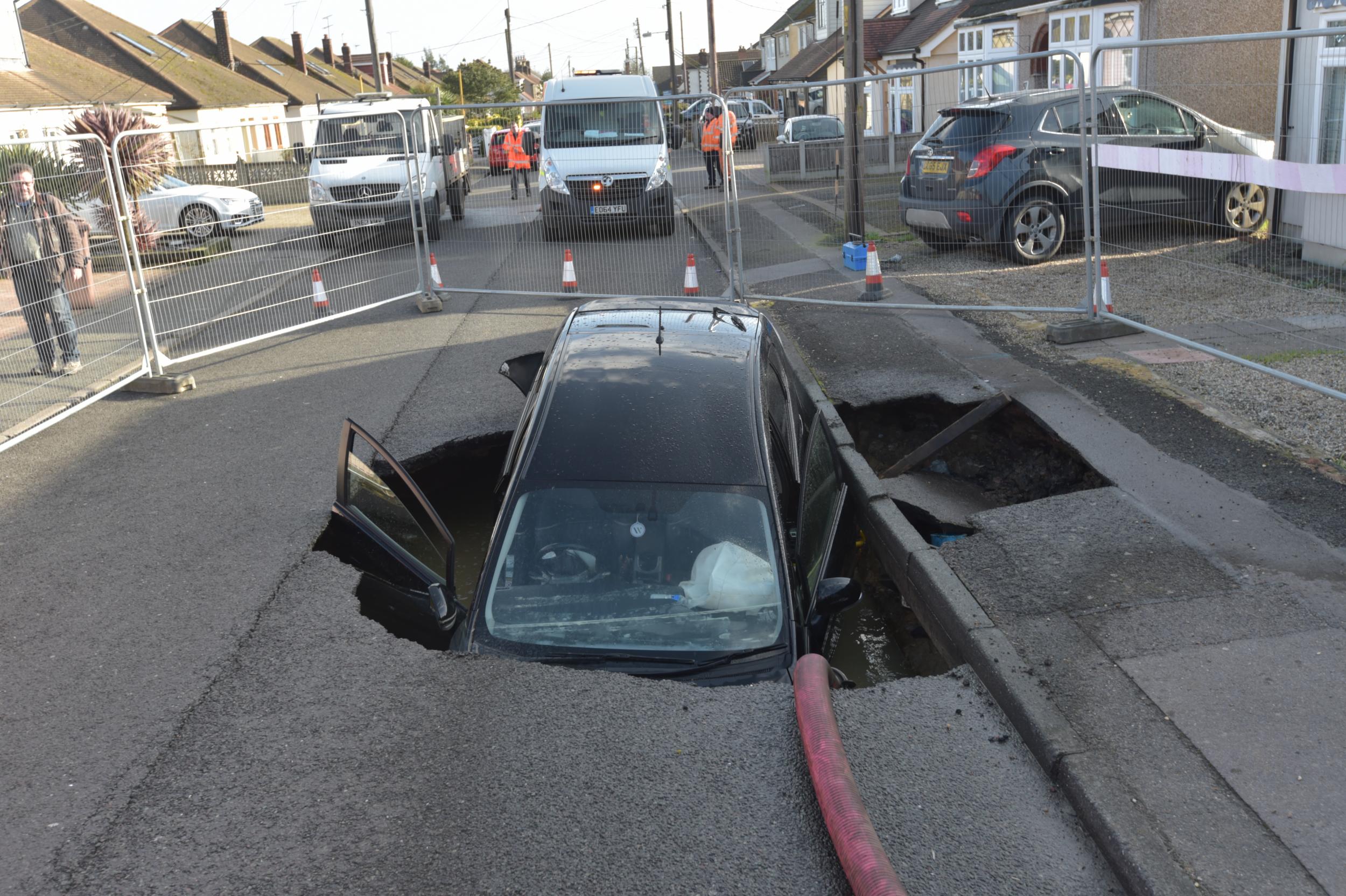 A Toyota car in a sinkhole which appeared overnight in Hatch Road, Brentwood, in the wake of Storm Ciara.