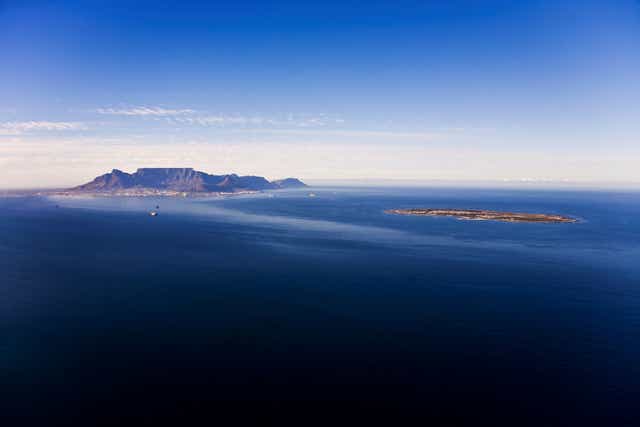 Aerial view of Robben Island with Table Mountain in the distance