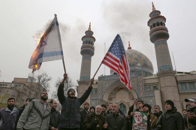 Israeli and a US flag are burned during protest over the killings of Iranian general Qasem Soleimani and Iraqi paramilitary chief Abu Mahdi al-Muhandis in an American airstrike
