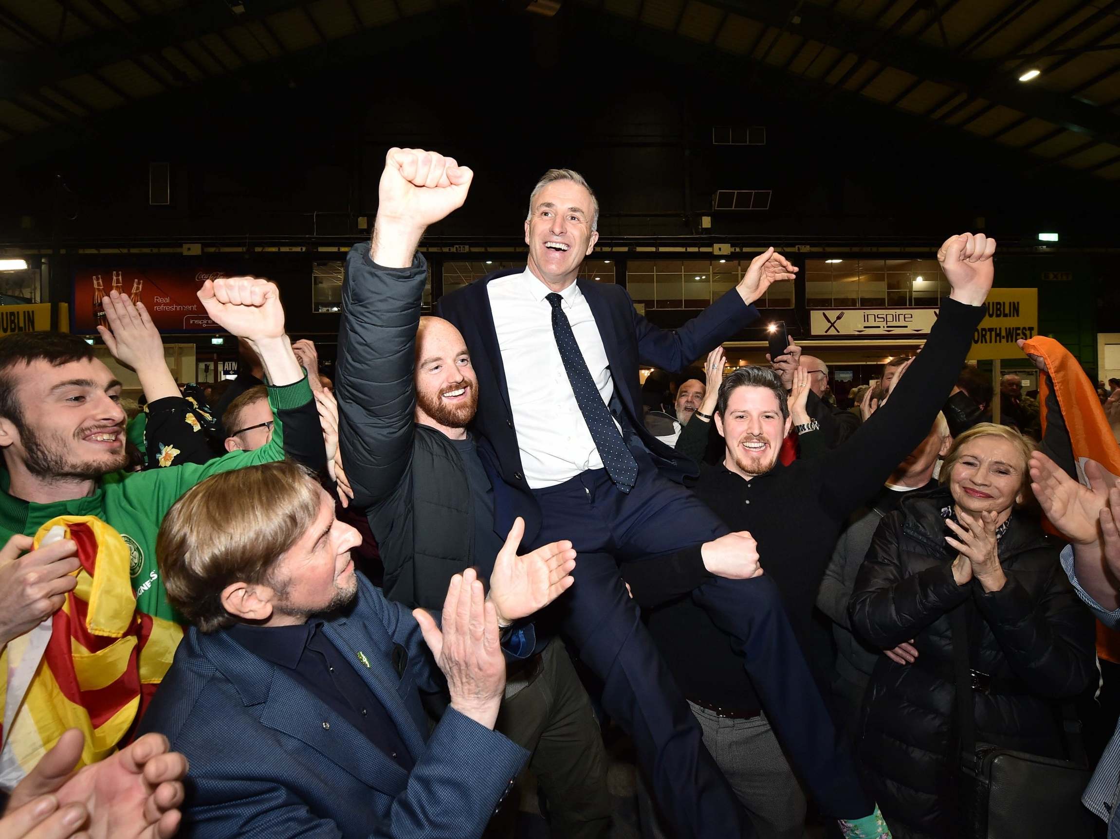 Newly elected Sinn Fein candidate Chris Andrews is held aloft by supporters