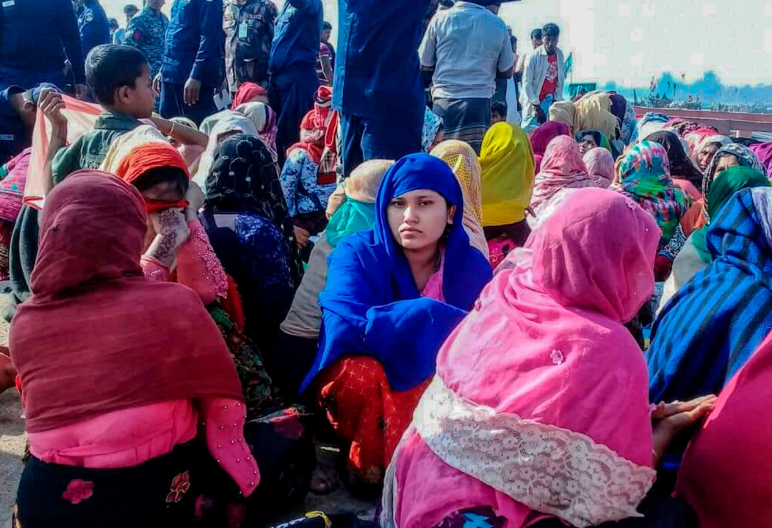 Rohingya refugees wait in an area following a fatal boat capsizing on Tuesday