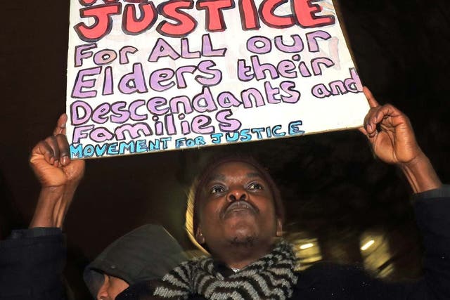 A campaigner in Parliament Square protests against the government's plans to deport 50 people to Jamaica, on 11 February 2020