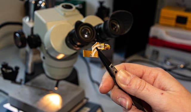This is the terahertz quantum cascade laser on its mounting. A pair of tweezers shows how small the device is