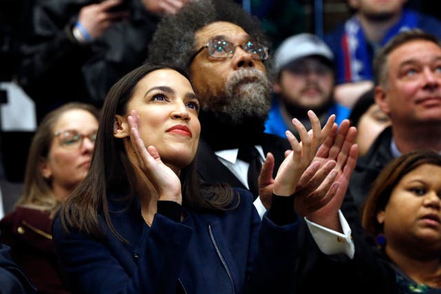 Congresswoman Alexandria Ocasio-Cortez applauds during a Bernie Sanders campaign rally in Durham, New Hampshire