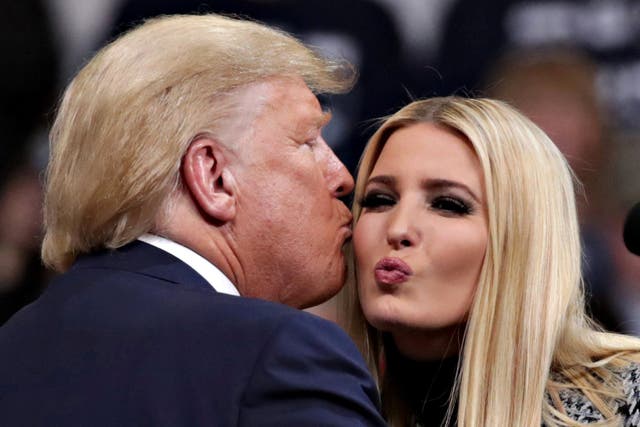 Donald Trump kisses his daughter Ivanka during a campaign rally in Manchester, New Hampshire