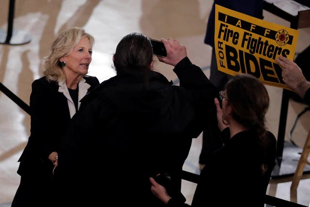 Jill Biden pushes away a protester who was trying to interrupt her husband Joe's speech at a campaign event in Manchester, New Hampshire