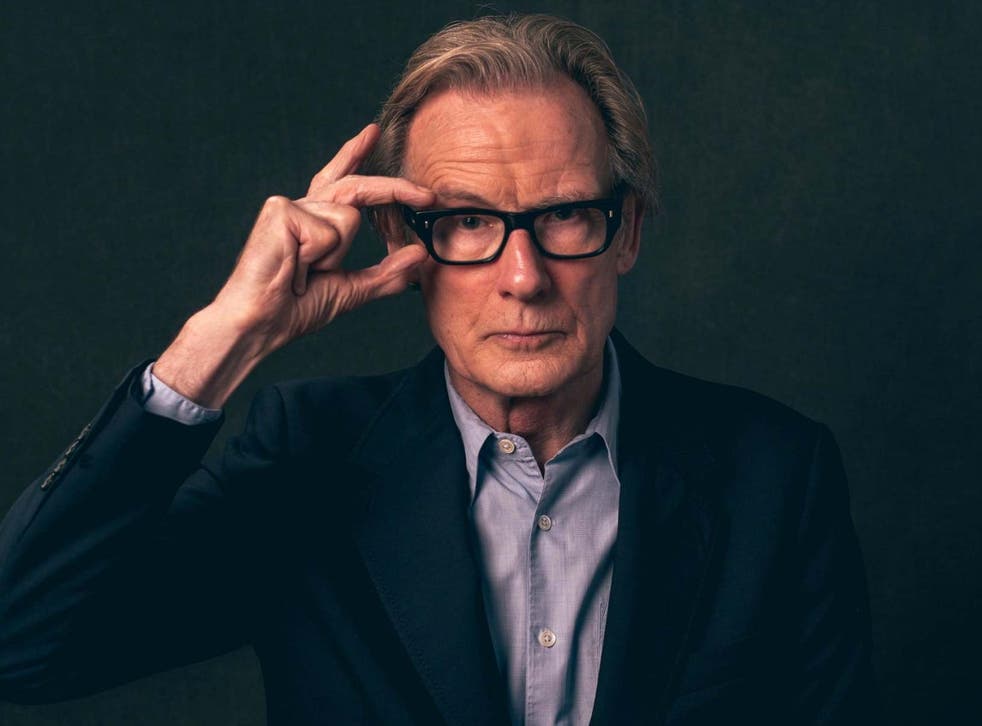 In a well-fitting navy suit and black specs, Nighy is still the suave heartthrob he always was