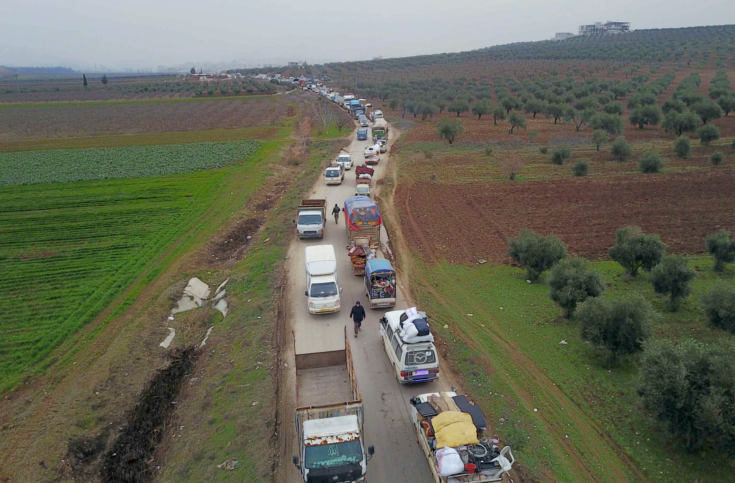 Civilians flee from Idlib to find safety inside Syria near the border with Turkey, 11 February 2020