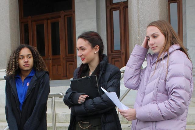 High school track athletes Alanna Smith, left, Selina Soule, centre and and Chelsea Mitchell prepare to speak at a news conference outside the Connecticut State Capitol in Hartford