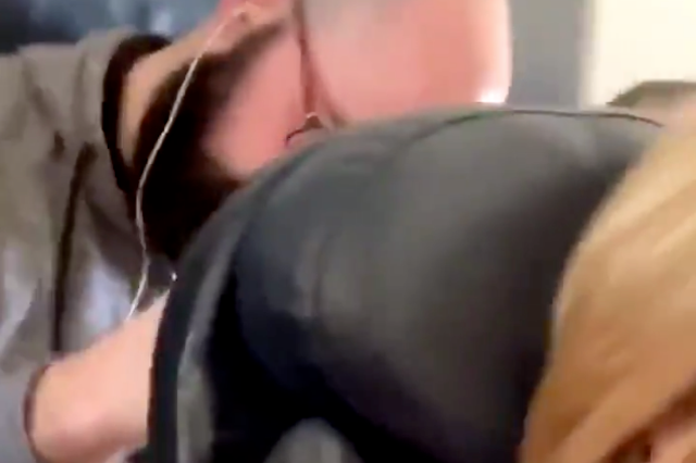 Footage of a woman being 'punched' by a male passenger onboard an American Airlines flight has gone viral