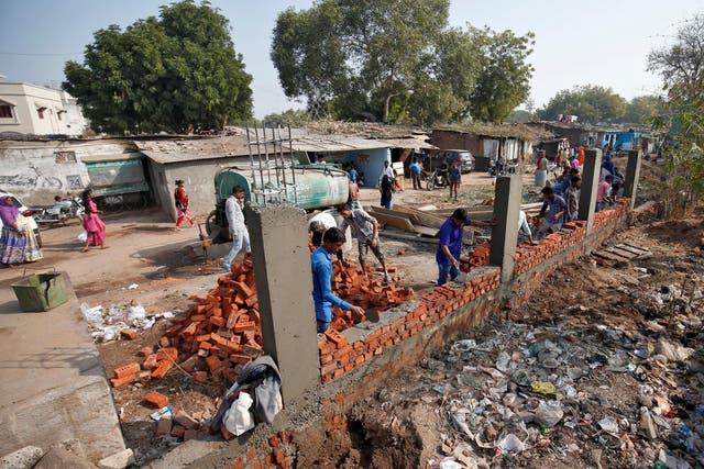 Constructors building the wall in Ahmedabad India 13 February 