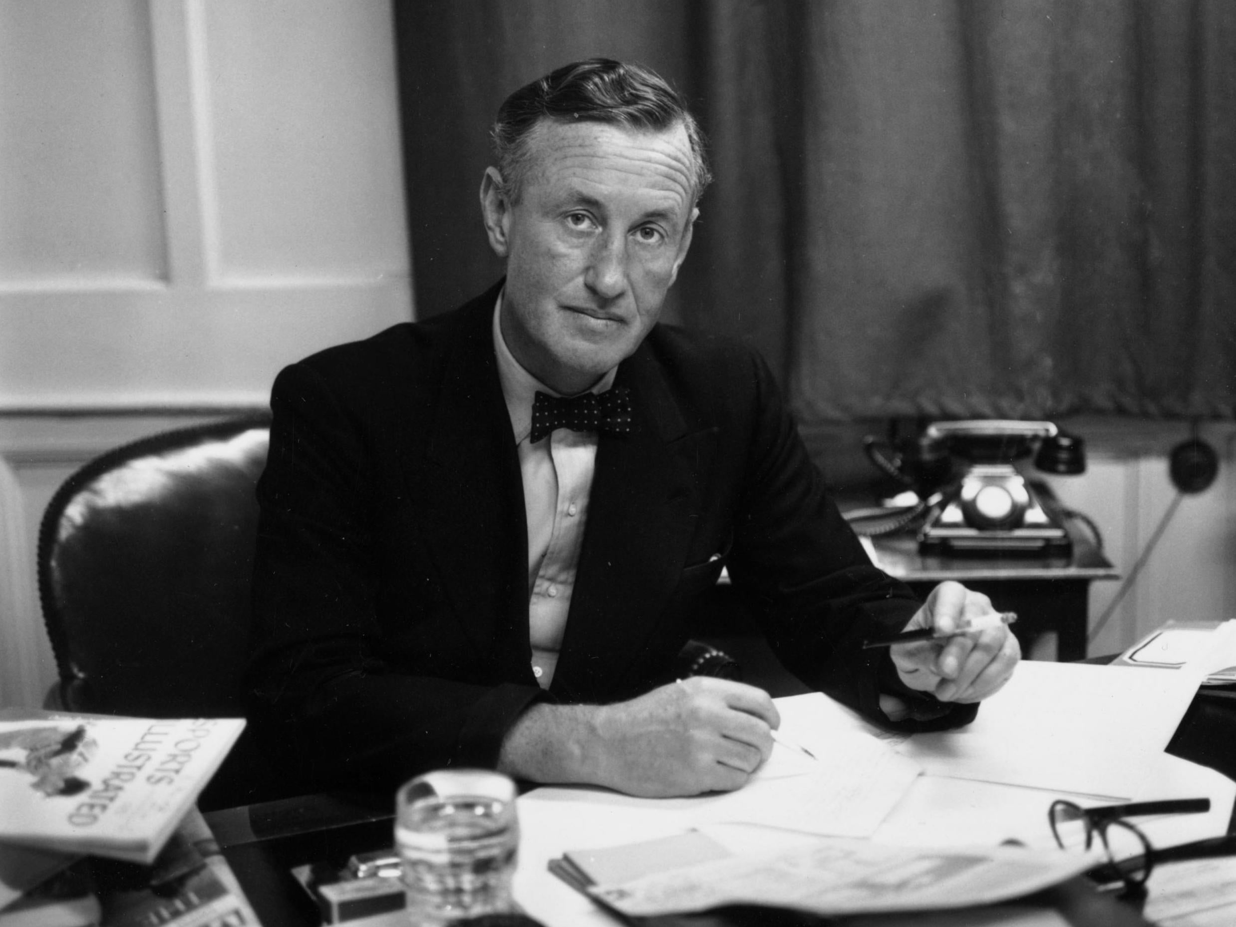 Bond creator and martini fan Ian Fleming at his desk in 1958. Fleming was a regular at some of London’s finest bars, especially Dukes in St James’s (Getty)